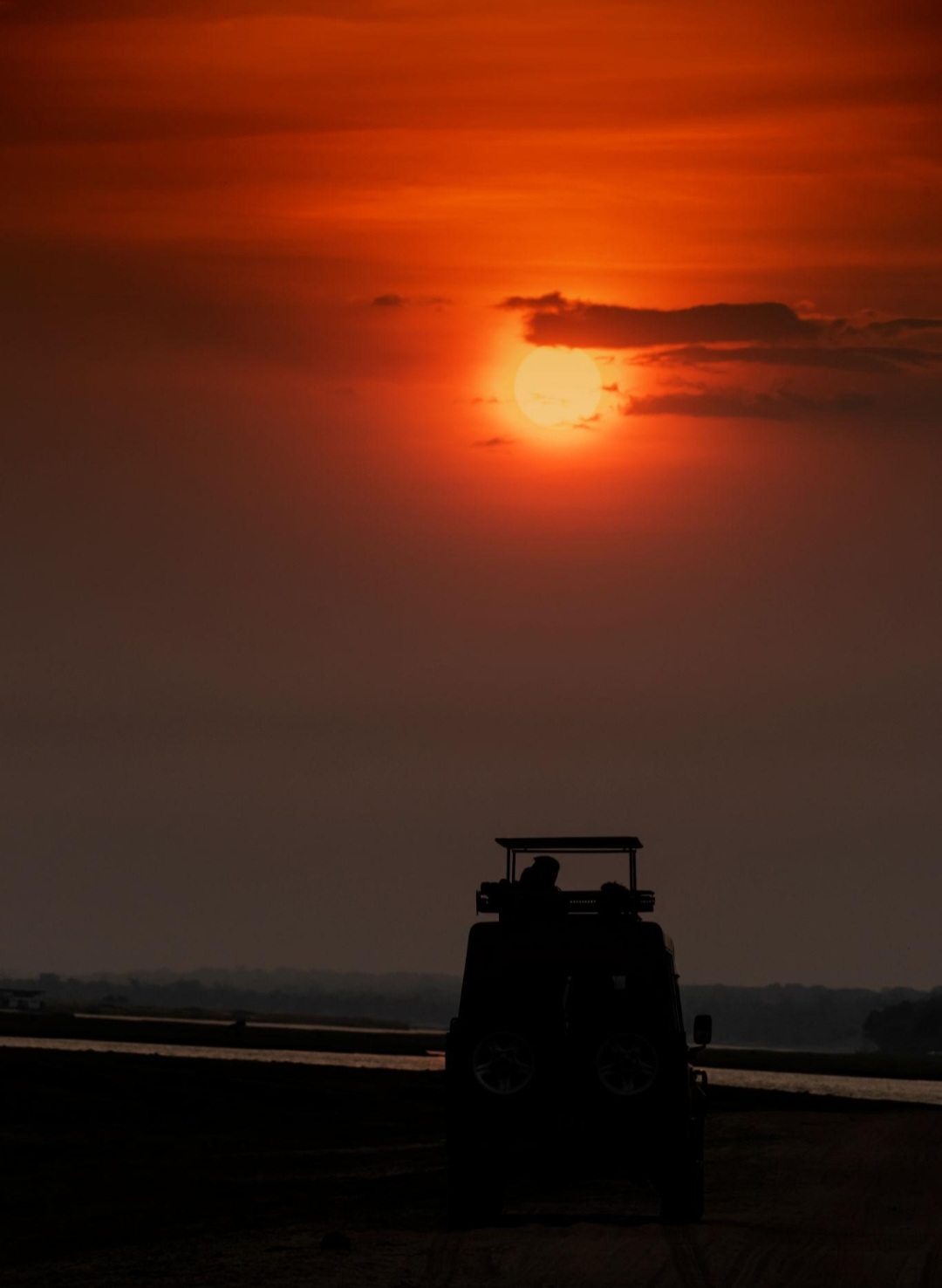 Safari vehicle at sunset, Maasai Mara
